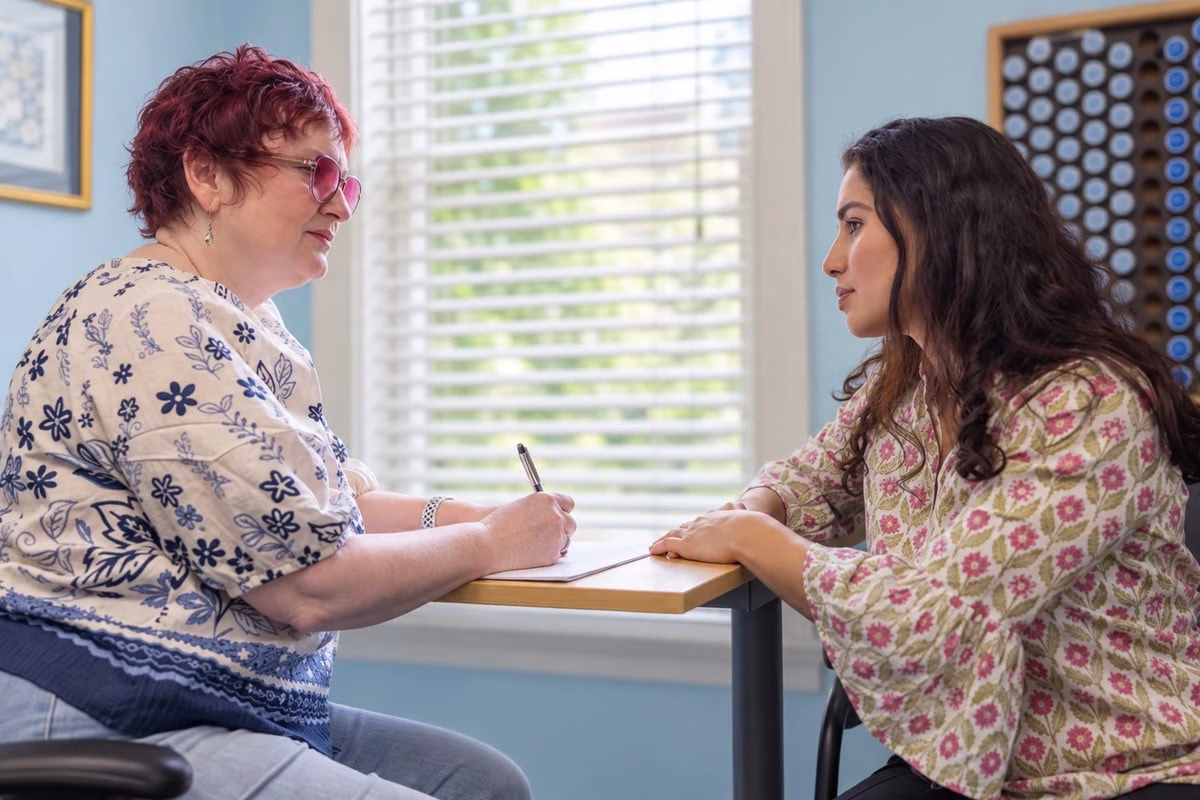 Dr. Billiot listening to a patient during a consultation