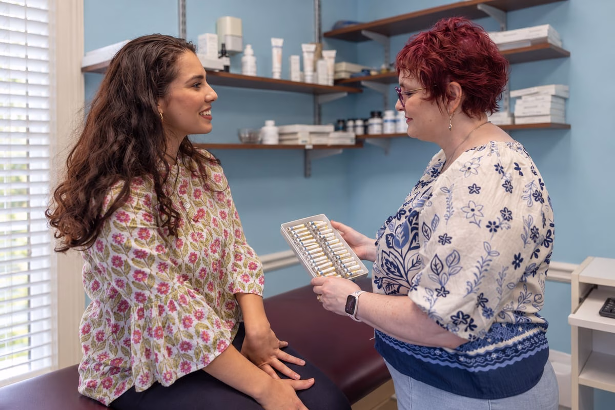 Dr. Billiot holding a testing tray while speaking with a patient